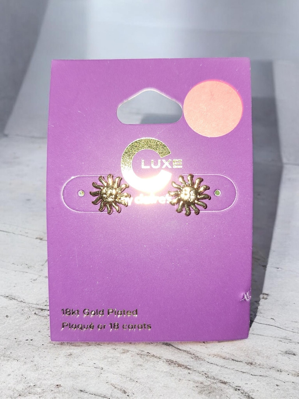 Luxe Gold Sunburst Stud Earrings on Purple Card